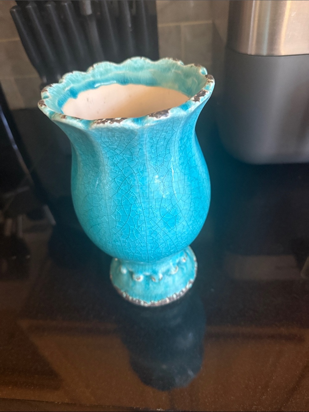 A turquoise crackle glaze ceramic vase with beaded pedestal base.